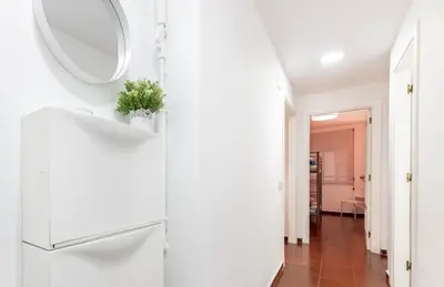 a white hallway with a mirror on a wall at Apartamento Centro Histórico Valencia de 2 habitaciones in Valencia