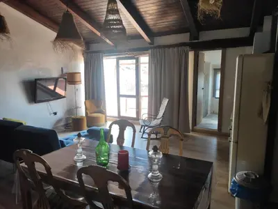 a dining room table and chairs in a living room at Ático El Más allá in Chulilla