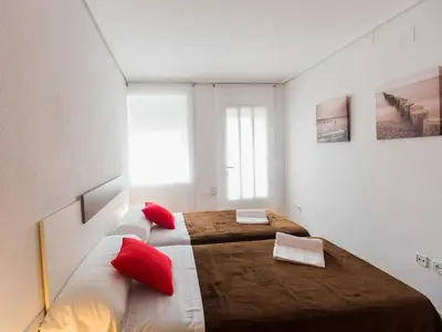 a bedroom with two beds with red pillows at Total Valencia Xàtiva (Leisure & Culture) in Valencia