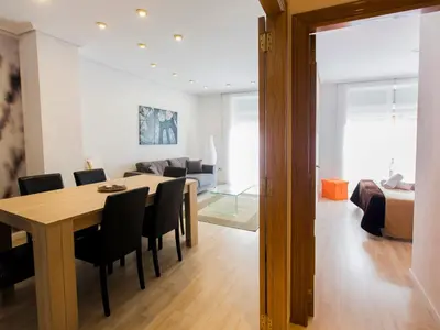 a dining room and living room with a table and chairs at Total Valencia Xàtiva (Leisure & Culture) in Valencia