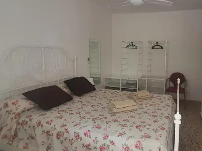 a bedroom with a large bed with a floral bedspread at La Chirrichana 2 in Bicorp