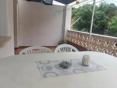 a white table and chairs in a room with a window at La Chirrichana 2 in Bicorp