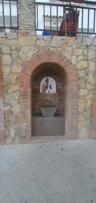 a brick fireplace with a statue of a horse in it at La Chirrichana 2 in Bicorp