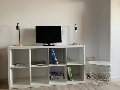 a white shelf with a tv on top of it at Cullera - Florazar II con piscina, tenis y club social in Cullera