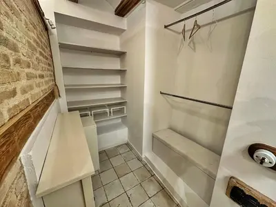 a walk in closet with white walls and shelves at Dulces Sueños Pilar in Valencia