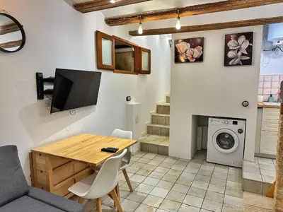 a living room with a table and a washing machine at Dulces Sueños Pilar in Valencia