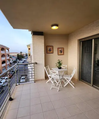 a balcony with a table and chairs on a building at Nuevo apartamento con A A a 2 minutos de la playa MASBO 2 in Moncófar