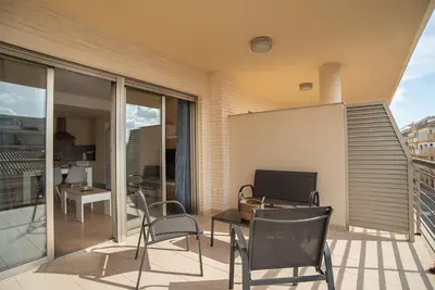 a patio with chairs and a table on a balcony at Nuevo apartamento en playa con aire acondicionado MASBO 3 in Moncófar