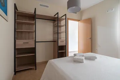 a bedroom with a bed and a closet at Nuevo apartamento en playa con aire acondicionado MASBO 3 in Moncófar