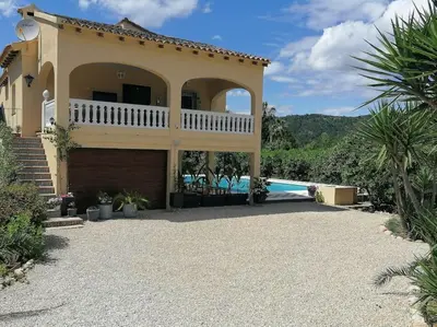 a villa with a swimming pool and a house at Villa Isabelle in Barraca de Aguas Vivas