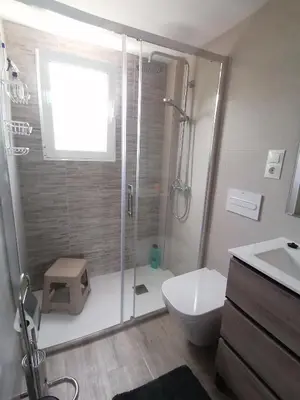 a bathroom with a shower and a toilet and a sink at Villa Isabelle in Barraca de Aguas Vivas