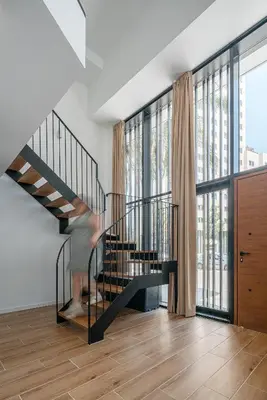 a person walking down a staircase in a house at TOP DUPLEX NUEVO A ESTRENAR ,CIUDAD DE LAS CIENCIAS in Valencia