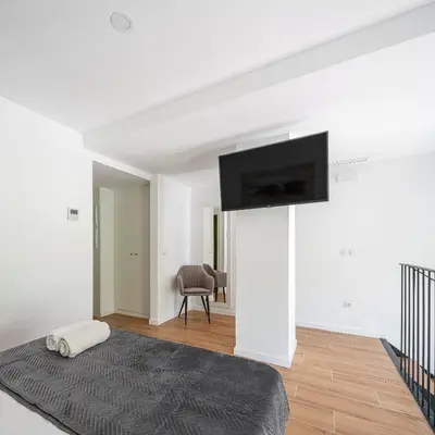 a white room with a flat screen tv on a wall at TOP DUPLEX NUEVO A ESTRENAR ,CIUDAD DE LAS CIENCIAS in Valencia