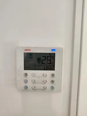 a white clock on a white wall at TOP DUPLEX NUEVO A ESTRENAR ,CIUDAD DE LAS CIENCIAS in Valencia