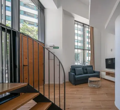 a living room with a couch and a television at TOP DUPLEX NUEVO A ESTRENAR ,CIUDAD DE LAS CIENCIAS in Valencia
