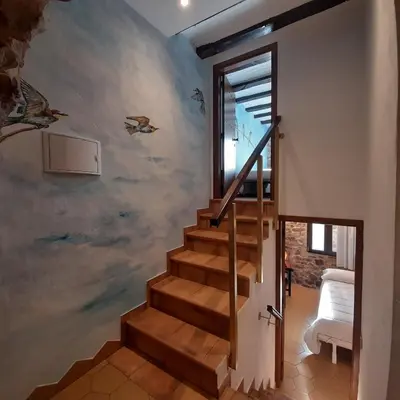 a staircase in a house with a mural on the wall at Casa rural rústica 
