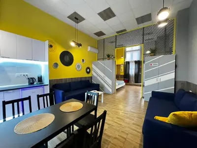 a kitchen and a living room with a table and chairs at Lliri 32 in Valencia