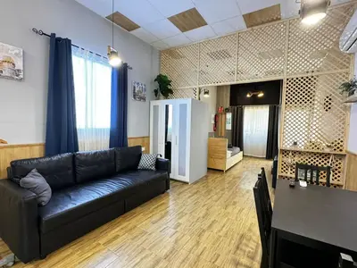a living room with a black couch and a table at Salom 5 in Valencia