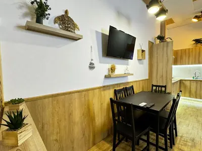 a dining room with a table and a tv on a wall at Salom 5 in Valencia