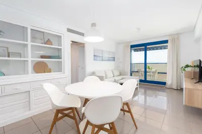 a white dining room with a white table and chairs at Patacona Breeze in Valencia