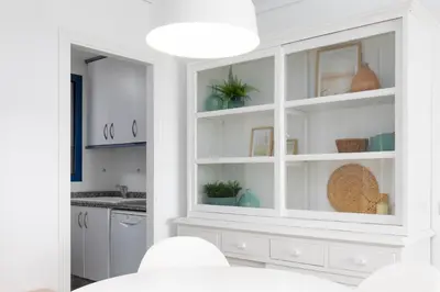 a kitchen with white cabinets and a sink at Patacona Breeze in Valencia