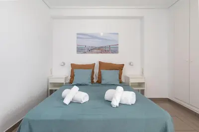 a bedroom with a bed with two pillows on it at Patacona Breeze in Valencia