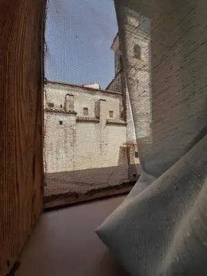 a white bed in a room with a window at ÁTICO RURAL 