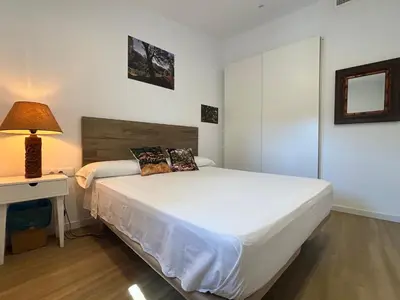 a bedroom with a bed and a lamp and a window at ÁTICO RURAL 