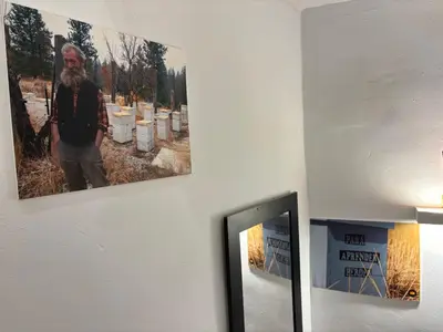 a staircase with a mirror and pictures on the wall at ÁTICO RURAL 
