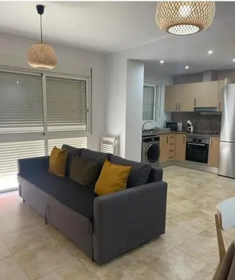 a living room with a couch and a kitchen at UIM Mediterraneo FELIPE 8 WIFI in Puerto de Sagunto