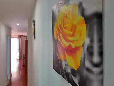 a picture of a yellow flower on a wall at Relax Les Palmeres in Sueca