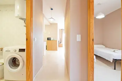 a laundry room with a washer and dryer at Global Vacacional, apartamento cerca del mar en Canet in Canet de Berenguer
