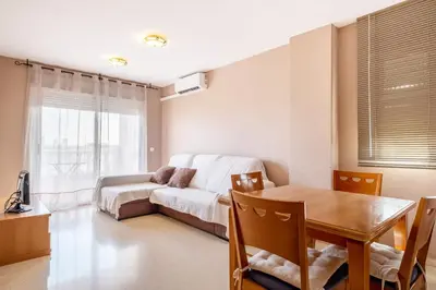 a living room with a couch and a table at Global Vacacional, apartamento cerca del mar en Canet in Canet de Berenguer