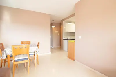 a kitchen and dining room with a table and chairs at Global Vacacional, apartamento cerca del mar en Canet in Canet de Berenguer