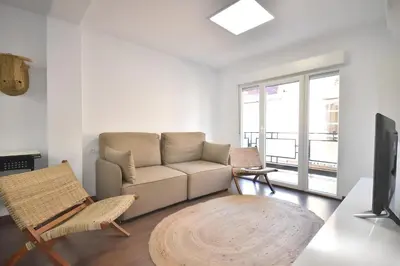 a living room with a couch and chairs and a television at Gran piso en barrio historico del centro in Valencia