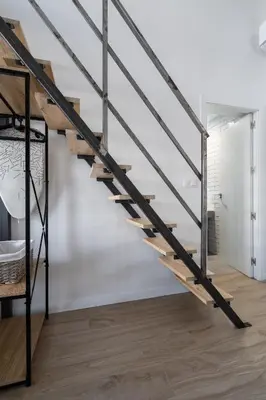 a metal and wood staircase in a room with a bed at Vip Apartments Valencia in Valencia