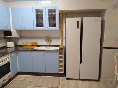 a kitchen with a white refrigerator and a sink at Casa con encanto y terraza junto a la playa in Valencia