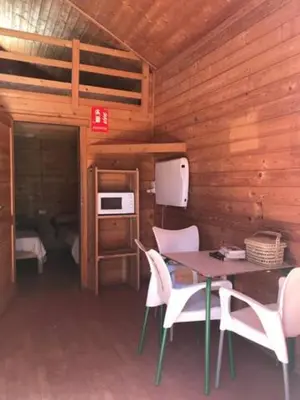 a dining room with a table and chairs in a cabin at Retiro Siete Aguas in Siete Aguas