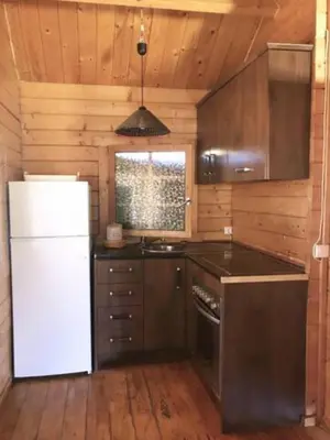 a kitchen with a white refrigerator and a stove at Retiro Siete Aguas in Siete Aguas