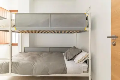 a bedroom with a bunk bed in a room at Vivienda junto a Ruzafa - 12 PAX y más in Valencia