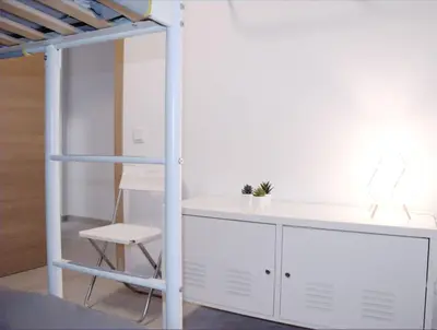 a room with a white desk and a ladder at Vivienda junto a Ruzafa - 12 PAX y más in Valencia