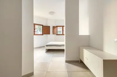 a bedroom with white walls and a bed at Vivienda junto a Ruzafa - 12 PAX y más in Valencia