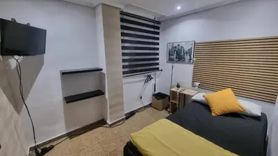 a small bedroom with a purple bed and a table at Private Room Valencia Center in Valencia
