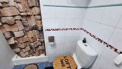 a bathroom with a white toilet and a wooden stool at Private Room Valencia Center in Valencia