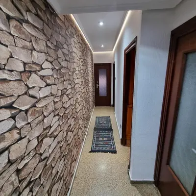 a hallway of a building with a stone wall at Private Room Valencia Center in Valencia