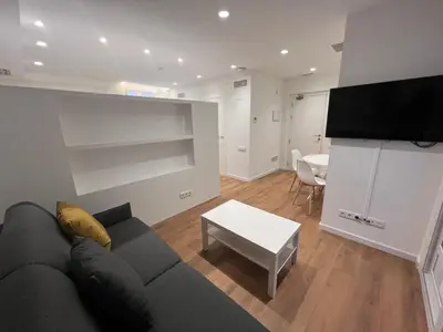 a living room with a couch and a table at Old Town Flats Casa del Bisbe in Valencia