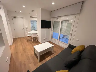 a living room with a couch and a table at Old Town Flats Casa del Bisbe in Valencia