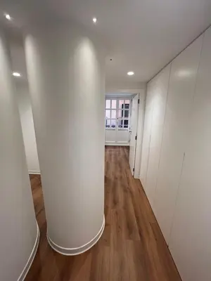 an empty hallway with white walls and wooden floors at Old Town Flats Casa del Bisbe in Valencia