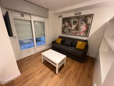a small living room with a couch and a table at Old Town Flats Casa del Bisbe in Valencia