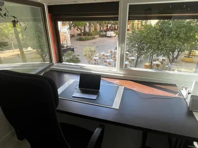 a laptop sitting on a desk in front of a window at Plaza del Carmen Boutique in Valencia